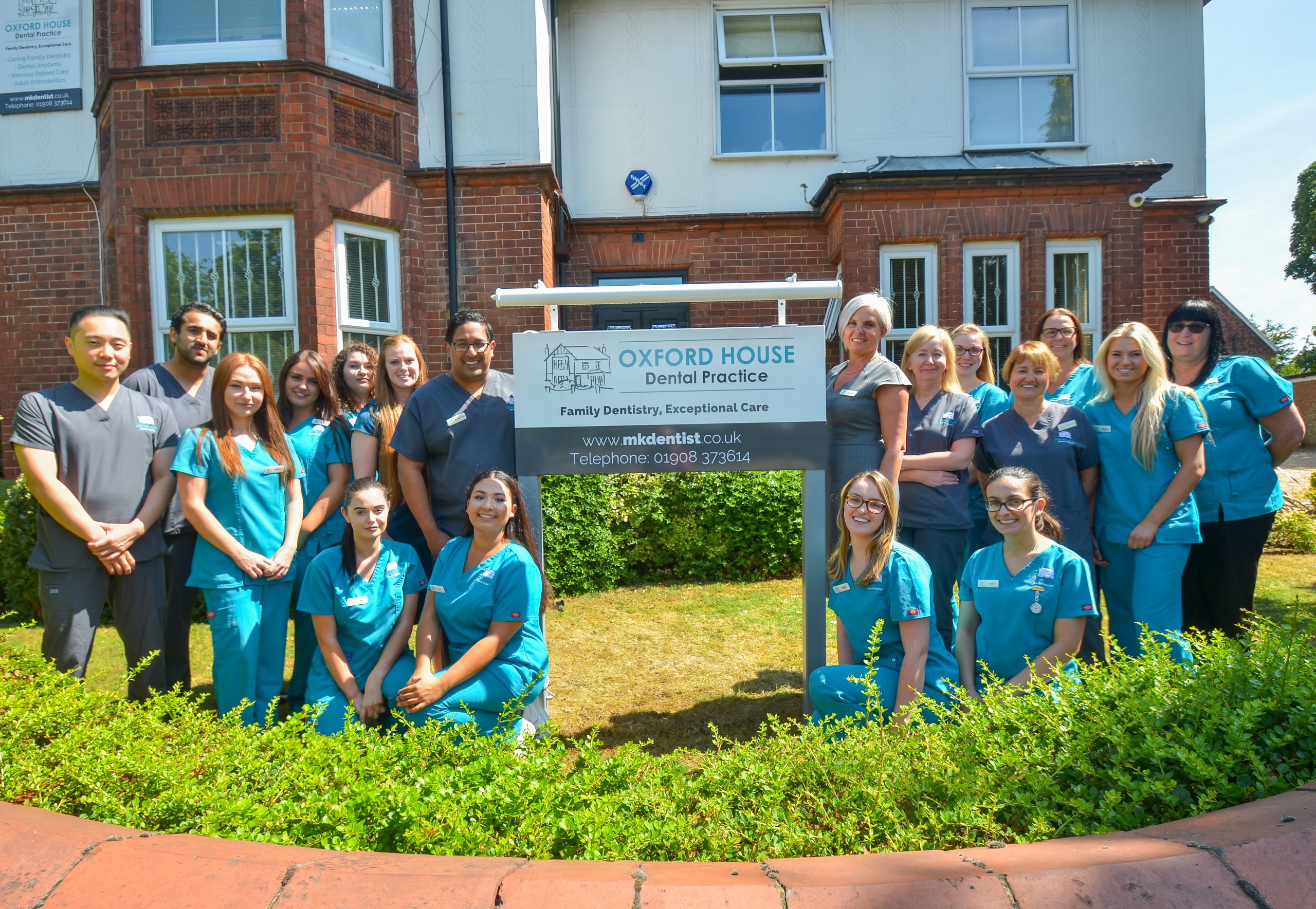 Oxford House Dental Practice posing happy after successful dental implant marketing campaign
